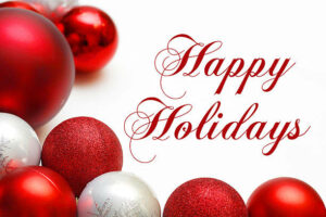 a group of silver and white sparkling Christmas Bulb Decorations are in the Bottom corner of a white background with the text Happy Holidays.