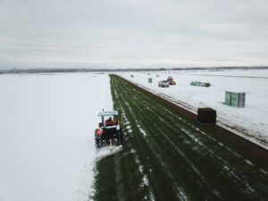 Blowing snow off the Kentucky Bluegrass to harvest it