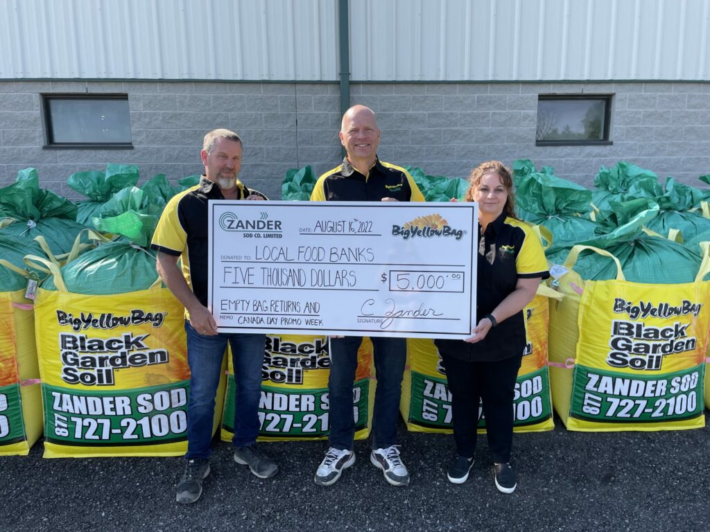 The Zander Sod BigYellowBag staff holding a $5000 cheque that we donated to local foodbanks with the help of our BigYellowBag customers.